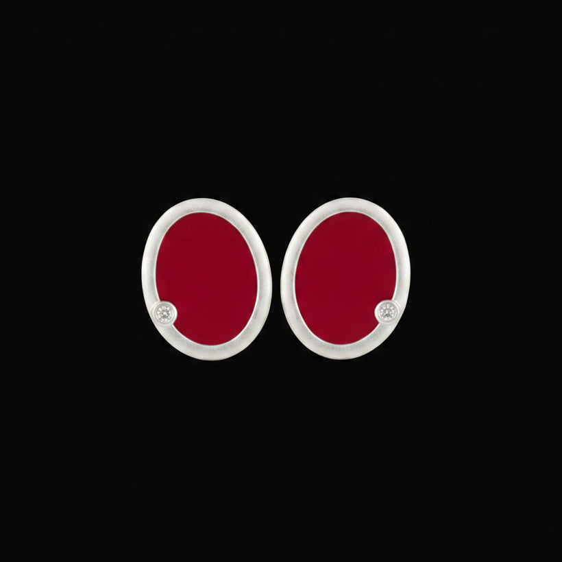 Close-up of silver oval earrings with red hot enamel detail - Tanti Jewellery