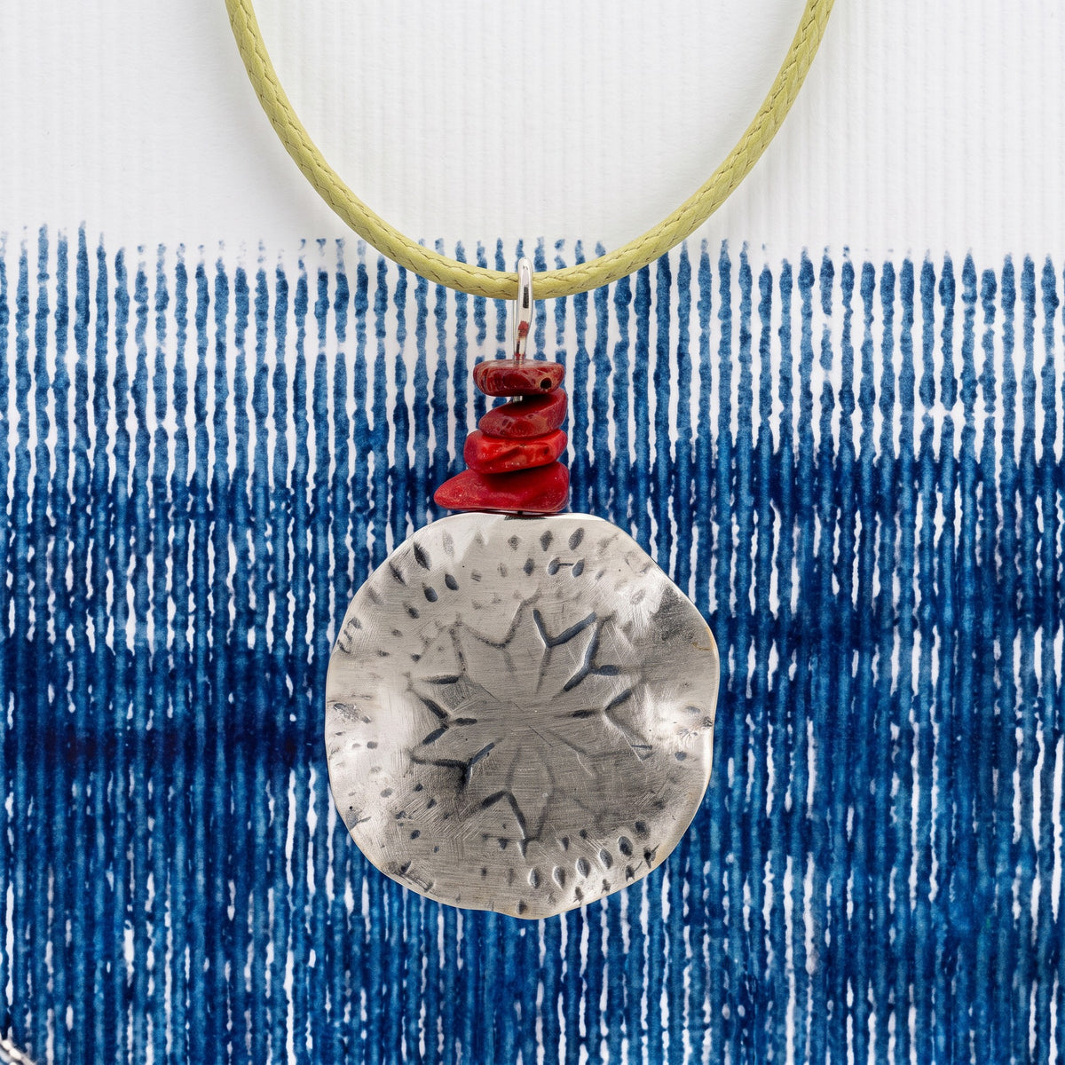 Polaris Necklace on a lemon-moss cord - styled on blue tie-dye fabric