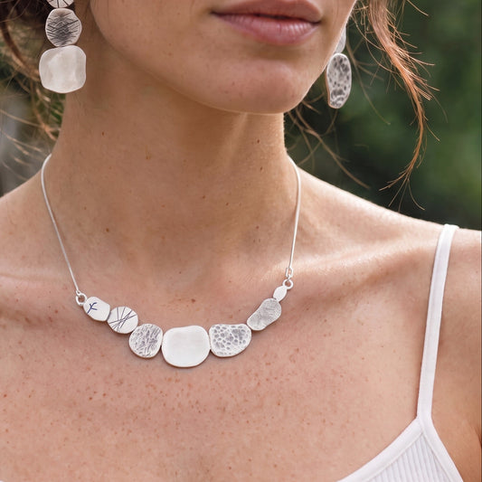 Stone Necklace worn with the matching Stone Earrings by a model in a white strappy top, close at the collarbone