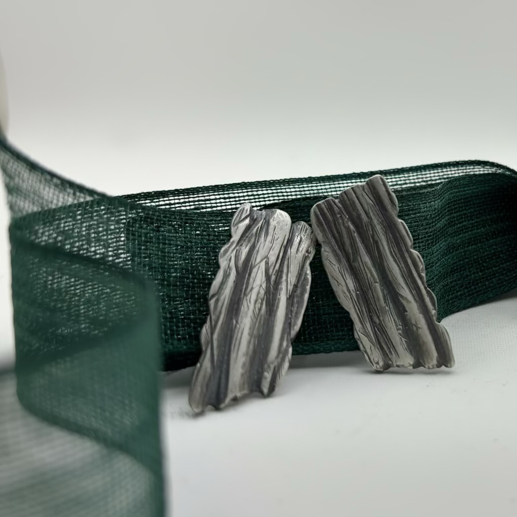 Tree Bark Earrings - worn on ear, on-model view