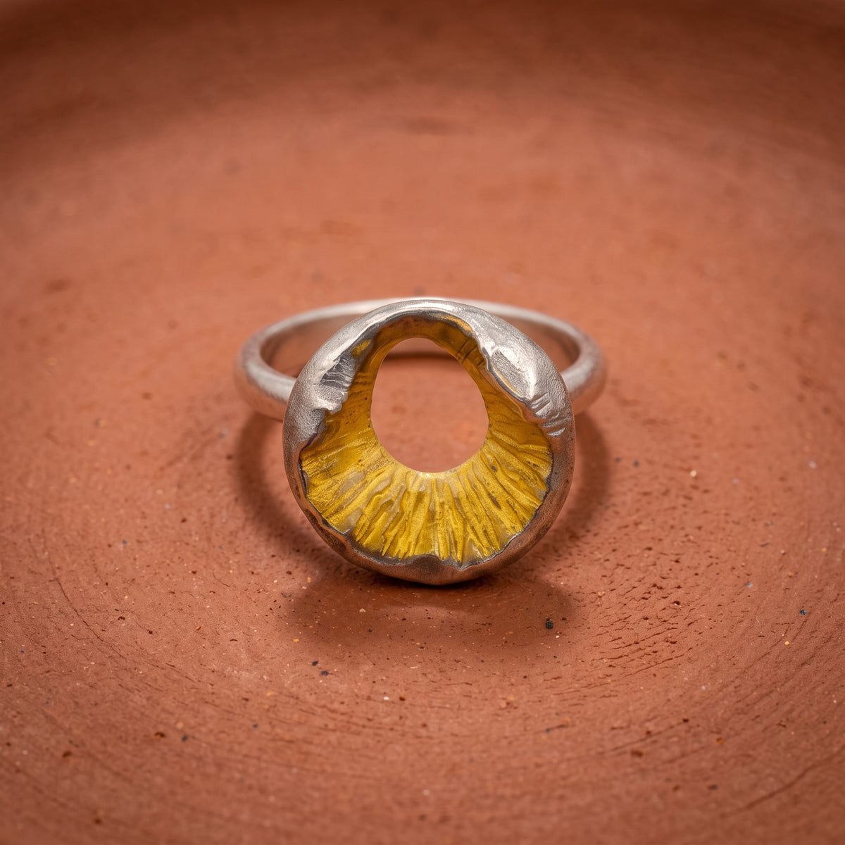 Volcano Ring – on terracotta clay, gold plated crater in a rhodium plated silver band